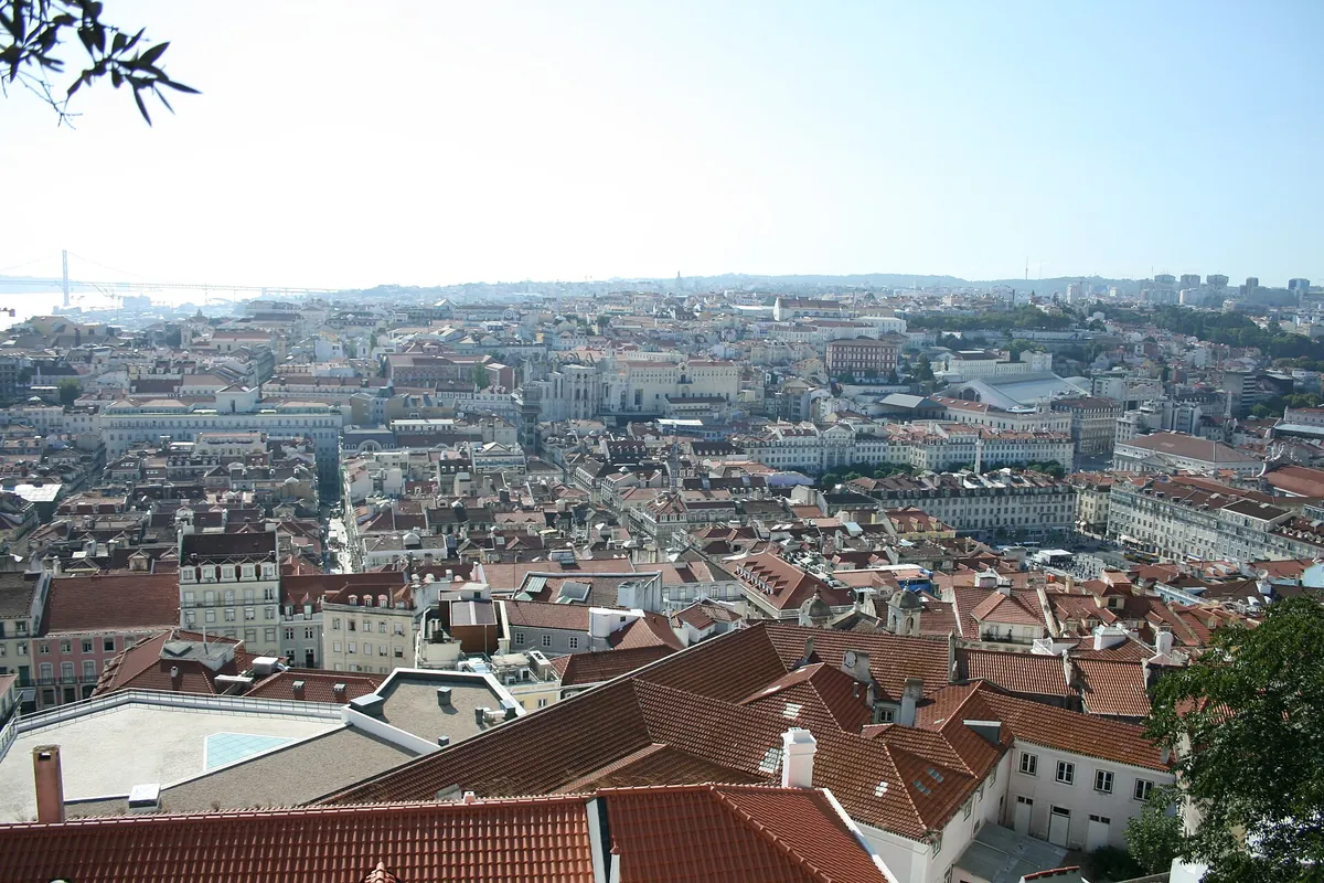 Looking over the red-tiled roofs of central Lisbon towards the river, the Baixa grid of streets laid out below
